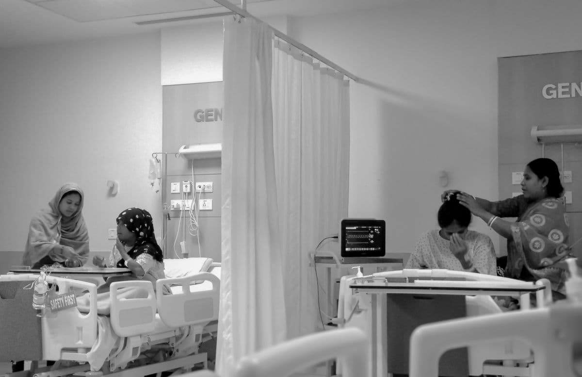 Family members supporting patients in a Kolkata hospital ward